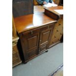 A reproduction mahogany side cabinet with a shallow drawer above two sets of hinged doors,