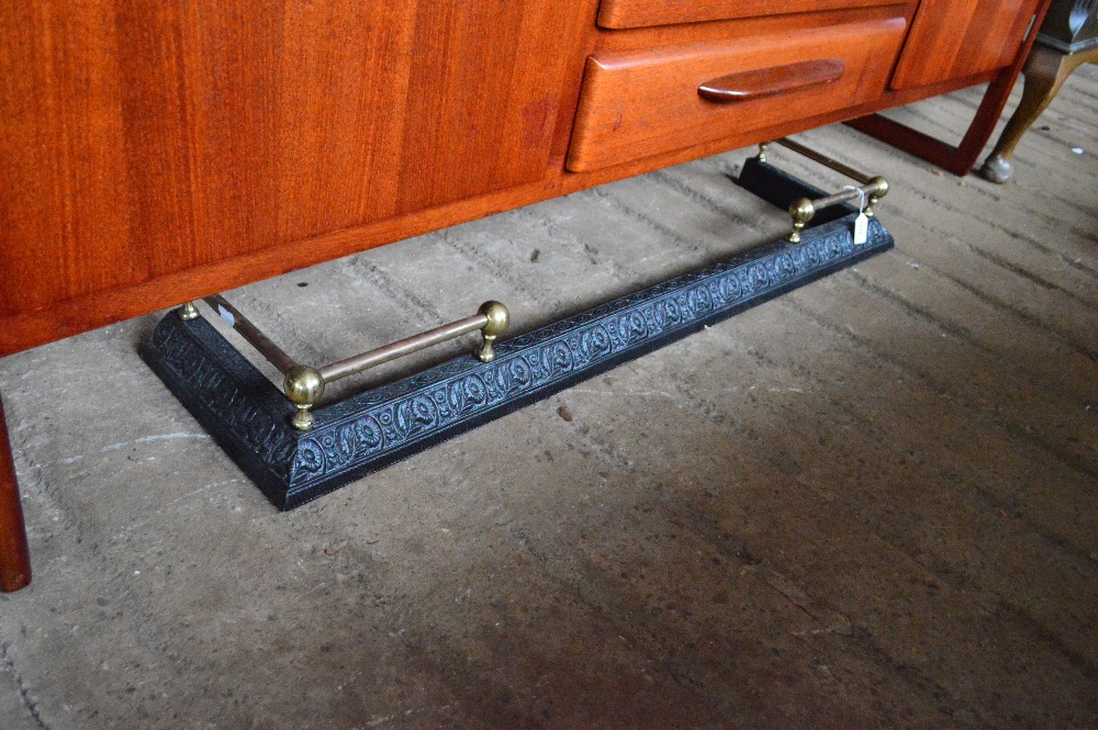 A cast iron and brass fender, width 117cm.