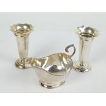 DEAKIN & FRANCIS; a pair of George V hallmarked silver bud vases with flared wavy rims,