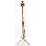 An Arts and Crafts copper and brass telescopic standard lamp with pierced scrolling frame.