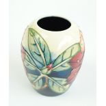 MOORCROFT; a small ovoid tube line decorated vase in 'Tropical Flowers' pattern,