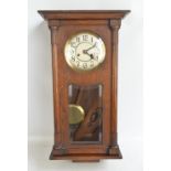 A 1940s oak wall clock with silvered dial set with Arabic numerals, length approx 71cm.