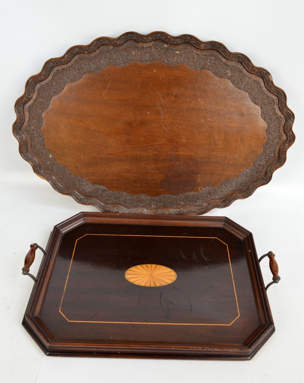 An Edwardian mahogany starburst motif inlaid twin handled rectangular tray with canted corners,
