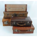 Five vintage suitcases in various sizes including four leather examples,