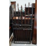 A pair of wrought iron decorated shaped gates with square section tubular frame.