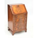 A reproduction mahogany four drawer bureau.