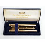 Three Sheaffer gold plated writing instruments, a fountain pen with nib stamped '585 14K',