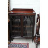 A 1930s mahogany bowfronted glazed two door display cabinet, width 90cm.