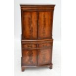 A reproduction mahogany and crossbanded cocktail cabinet with cupboard doors and two drawers.