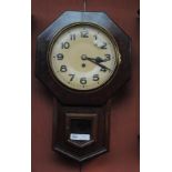 A stained beech octagonal drop dial wall clock with circular dials set with Arabic numerals.