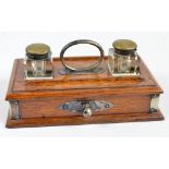 An Edwardian oak rectangular ink stand with loop handle,