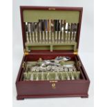 A cased twelve setting canteen of silver plated cutlery, serving utensils and flatware,