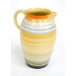 SHELLEY; a large spunware ribbed ovoid jug in orange, yellow and grey, mark to base, height 25.5cm.