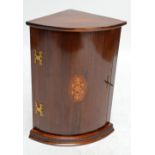 A reproduction mahogany bowfronted corner cupboard of small proportions.