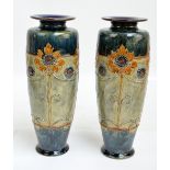 A pair of Royal Doulton Lambeth vases of tall baluster form with outswept rims,