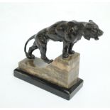 An Art Deco bronzed spelter and black slate mounted model of a lioness, length 15cm.