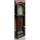 An early 19th century and later carved oak longcase clock with domed hood above arched brass dial