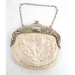 A silk floral bead decorated evening purse with alpaca mount with embossed decoration,