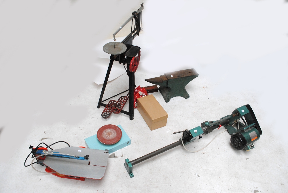 A quantity of tools including a lathe.