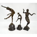 Three Art Deco style bronze female figures on marble effect plinths comprising a juggling nude,