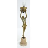 An Art Deco painted spelter figural lamp base modelled as a dancer holding a fluted bowl aloft,