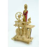 A prisoner of war carved bone automaton of a lady with a spinning wheel, height 11cm.