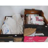 Three boxes of linen including a christening gown, table cloth, embroidery, etc.