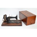 A walnut and inlaid case Friester & Rossman sewing machine (missing handle).