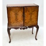 A 1930s/1940s walnut cocktail cabinet.