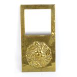 An Arts and Crafts brass wall mirror with square section plates above raised embossed stylised