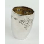 A possibly Norwegian silver beaker of ovoid form with hammered body and embossed foliate scroll