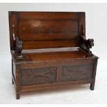 A c.1900 carved oak box seat monk's bench, width 106cm.