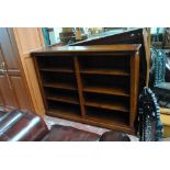 A reproduction oak open bookcase with moulded rectangular top and two banks of two sections of