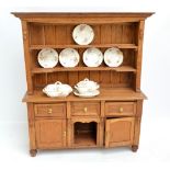 A miniature oak dresser with plate rack above three drawers,