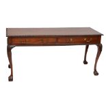 A reproduction mahogany serving table with two frieze drawers, cabriole legs and ball and claw feet,