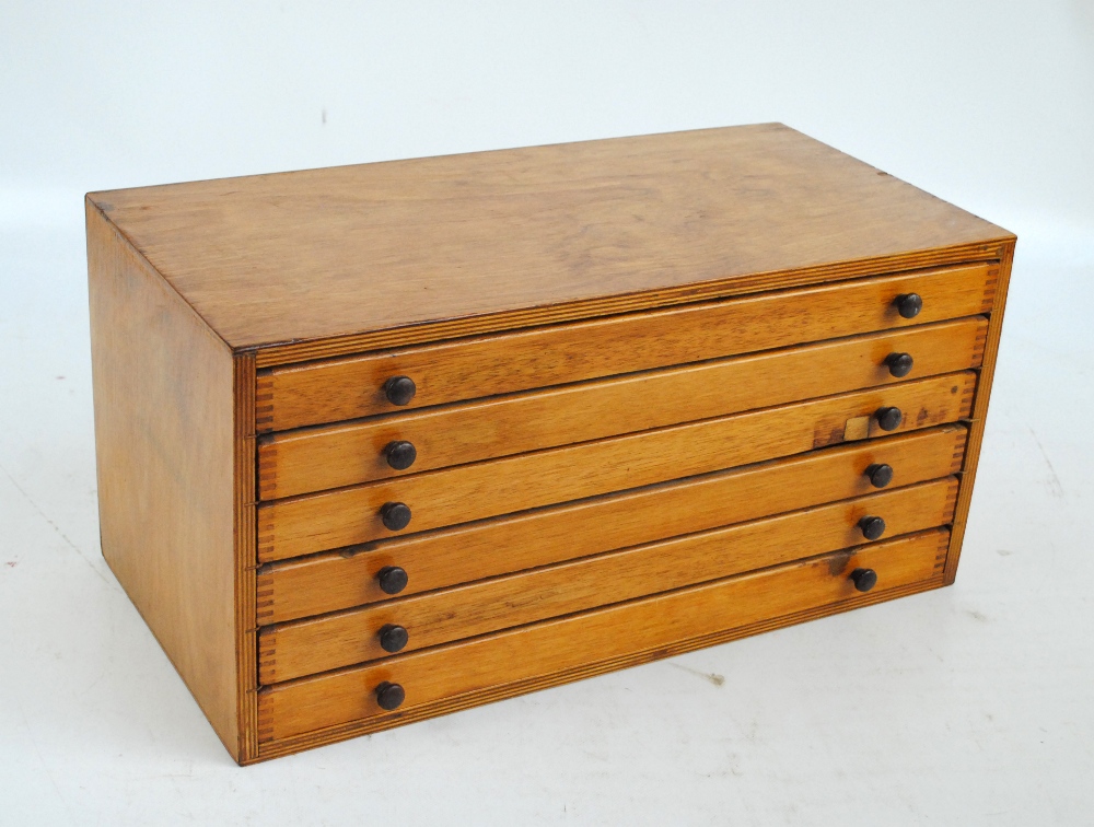 A laminated wood desktop coin/collectors' cabinet with six drawers,