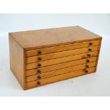 A laminated wood desktop coin/collectors' cabinet with six drawers,