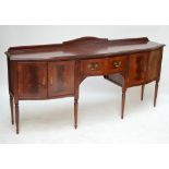 A reproduction mahogany serpentine outlined sideboard.