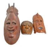 Three tribal carved wooden masks, length 64cm, 32cm and 21cm (3).