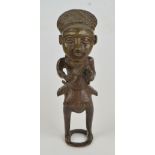 A West African Benin bronze figure of a bearded man drinking from a horn, on an open circular base,