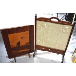 A mahogany-framed silk embroidery screen and a further marquetry fire screen depicting a boat in