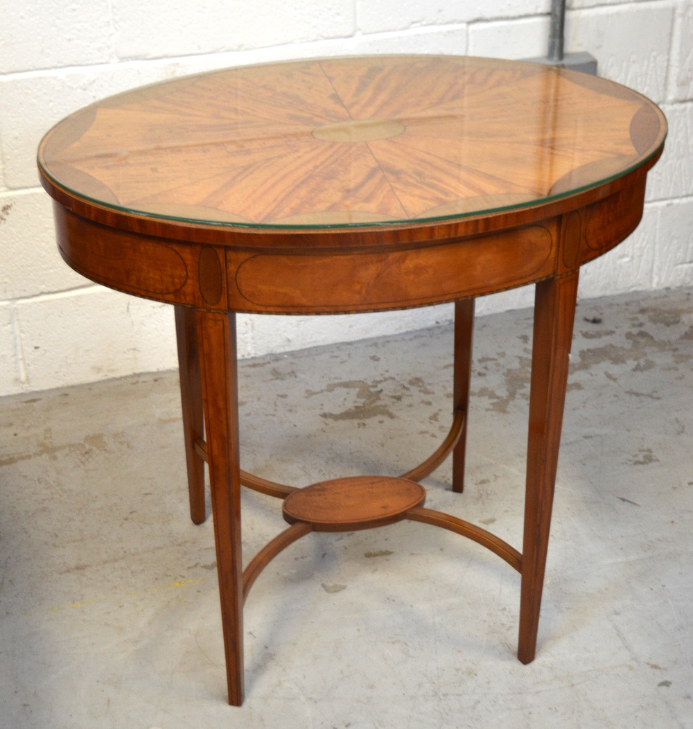 An Edwardian inlaid satinwood oval occasional table with converging cross stretchers to lower