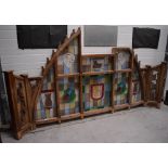 A large late Victorian pitch pine and leaded stained glass screen, width approx 310cm.