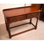 A mid-20th century 'Old Charm' oak hall table with two short carved drawers, on turned legs,