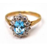 A 9ct gold dress ring with central aqua-coloured oval stone, white stone surround, size R, approx 3.