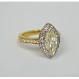 An 18ct yellow gold marquise-set halo diamond ring with melee diamonds set to shoulders,