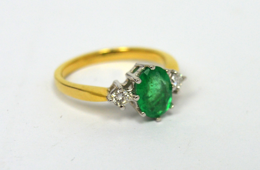 An 18ct yellow gold oval emerald (approx 1ct) and diamond ring, size M, approx 3.6g.