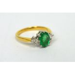 An 18ct yellow gold oval emerald (approx 1ct) and diamond ring, size M, approx 3.6g.