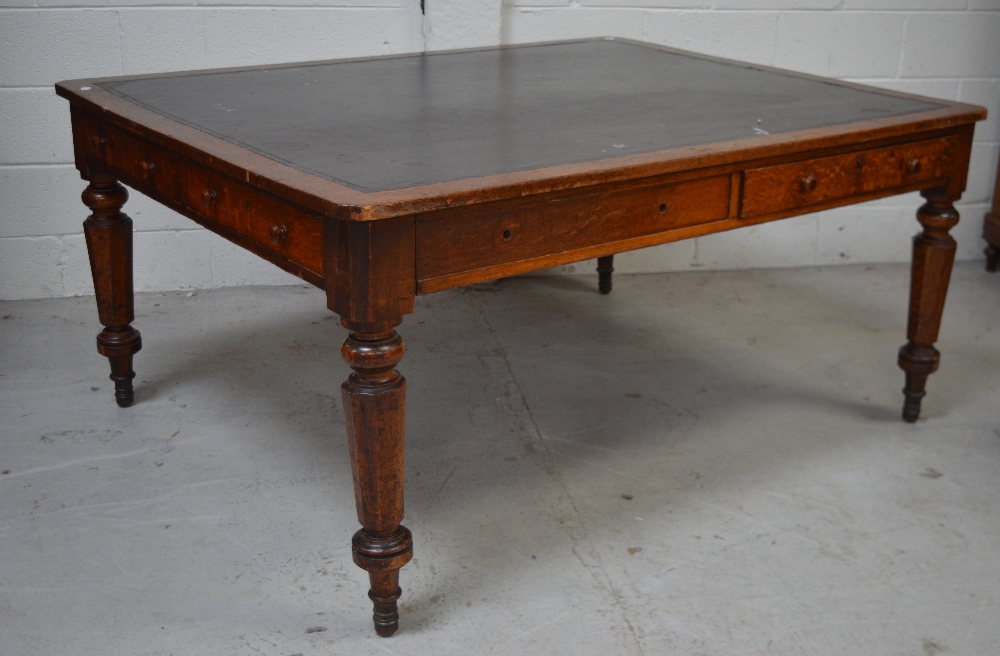 An Edwardian library oak table with leather insert,