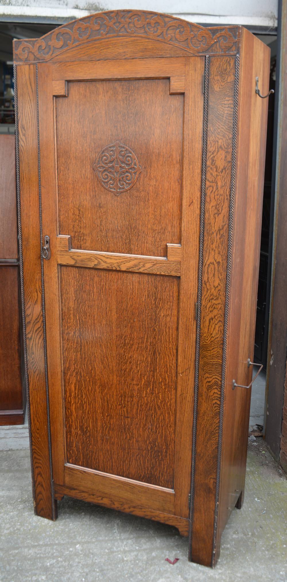 A 1920s oak hall robe, panelled with moulded cornice, interior with mirror,